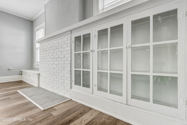 details with hardwood / wood-style floors and ornamental molding