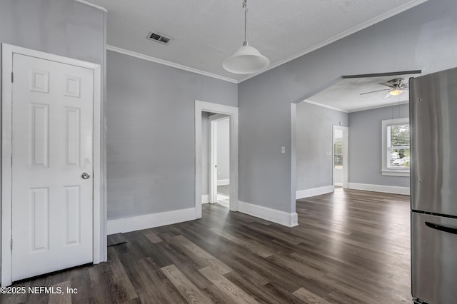 spare room featuring ceiling fan, ornamental molding, and a textured ceiling