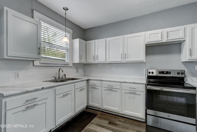 kitchen with stainless steel range with electric stovetop, white cabinets, tasteful backsplash, and sink