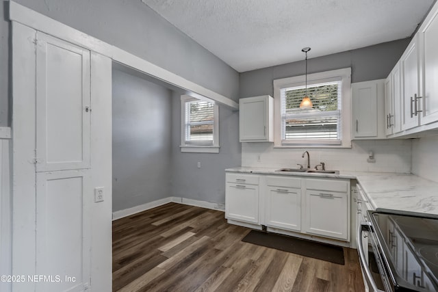 kitchen featuring sink, white cabinetry, and tasteful backsplash