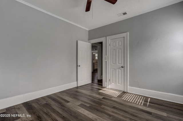 empty room with ceiling fan, crown molding, and dark hardwood / wood-style floors