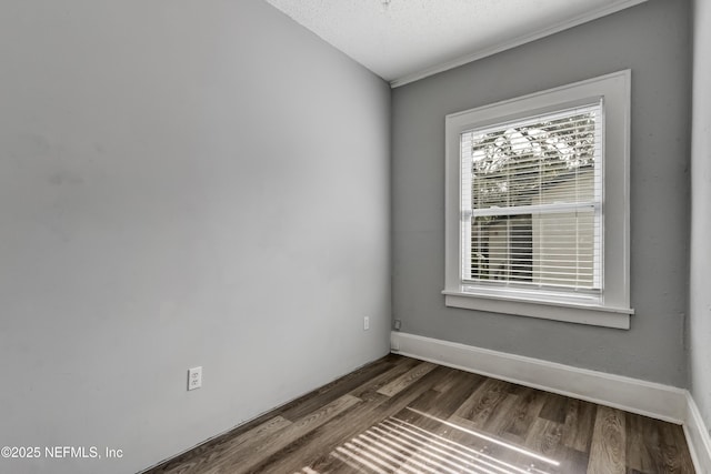 unfurnished room featuring a textured ceiling and dark hardwood / wood-style flooring