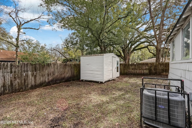 view of yard featuring central air condition unit and a storage shed