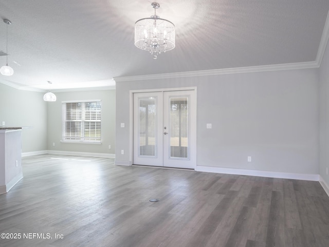 interior space with crown molding, hardwood / wood-style flooring, a textured ceiling, french doors, and a chandelier