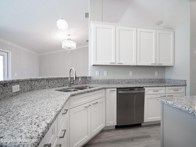 kitchen featuring dishwasher, sink, white cabinetry, hanging light fixtures, and light stone counters