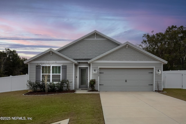 view of front facade with a yard and a garage