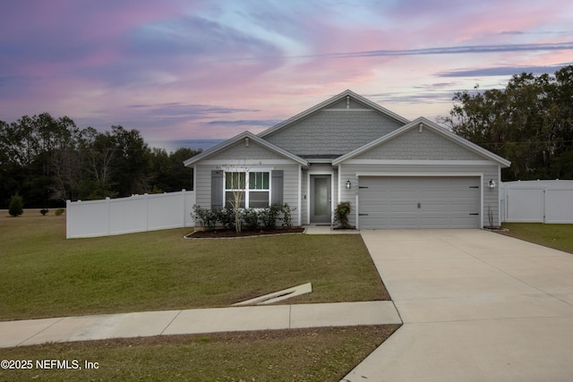 view of front facade with a garage and a yard