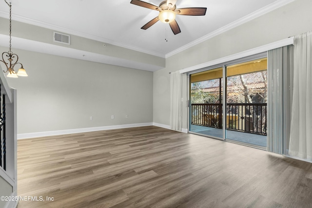 spare room featuring ornamental molding, ceiling fan with notable chandelier, and hardwood / wood-style flooring