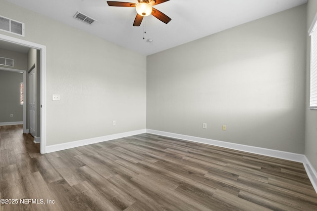 unfurnished room featuring ceiling fan and dark hardwood / wood-style flooring