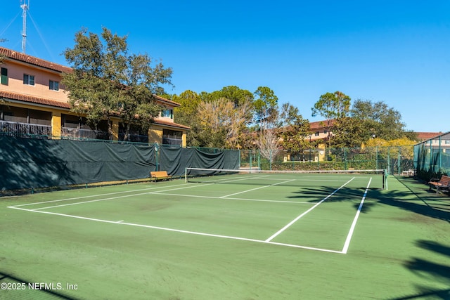 view of tennis court featuring basketball hoop