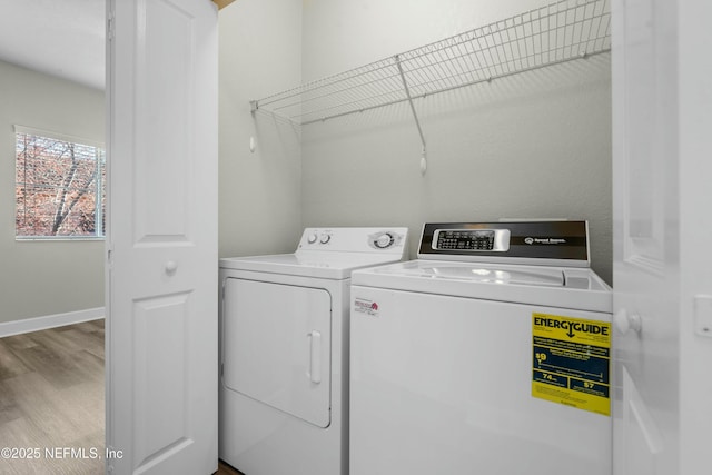 laundry area with washer and clothes dryer and hardwood / wood-style floors