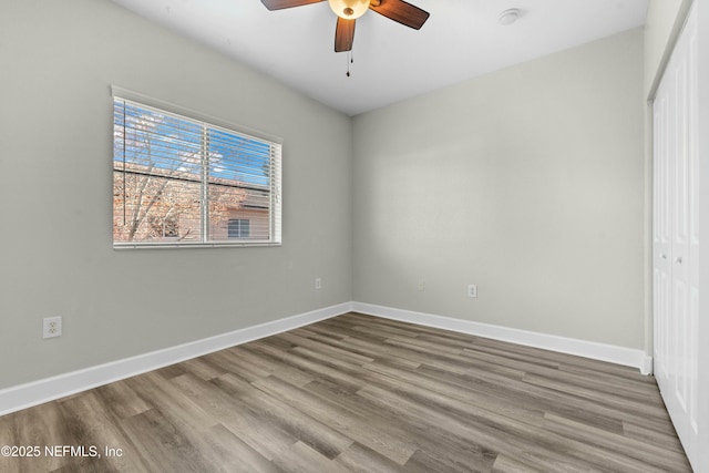 unfurnished bedroom featuring ceiling fan, hardwood / wood-style floors, and a closet