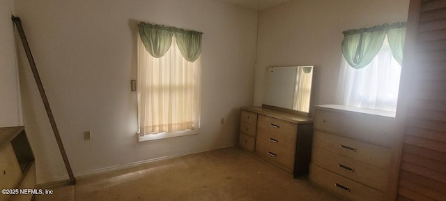 unfurnished bedroom featuring light carpet