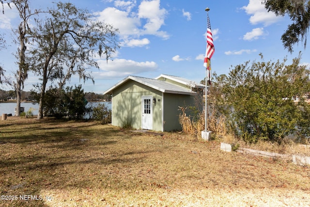 view of outbuilding with a water view