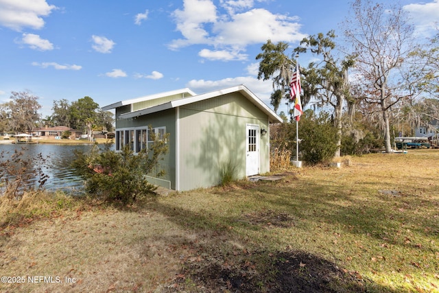 view of property exterior featuring a yard and a water view