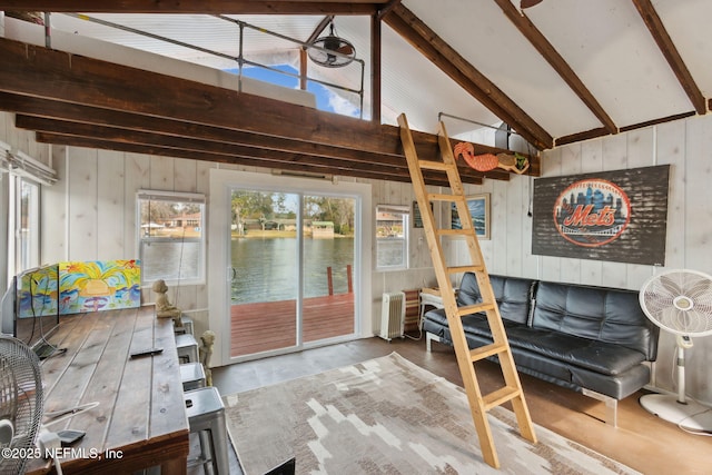 living room with beam ceiling, high vaulted ceiling, wood walls, and radiator heating unit