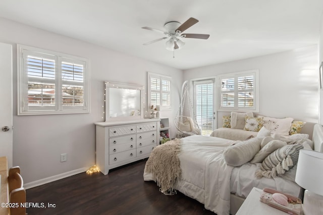 bedroom with ceiling fan, baseboards, and dark wood finished floors