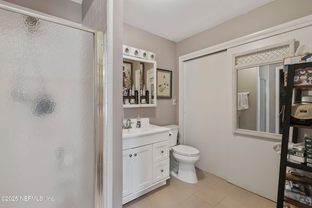 full bath with vanity, toilet, a stall shower, and tile patterned flooring