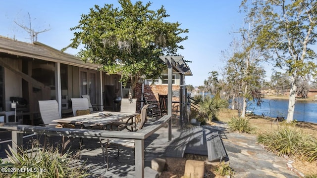 view of patio with outdoor dining area and a water view