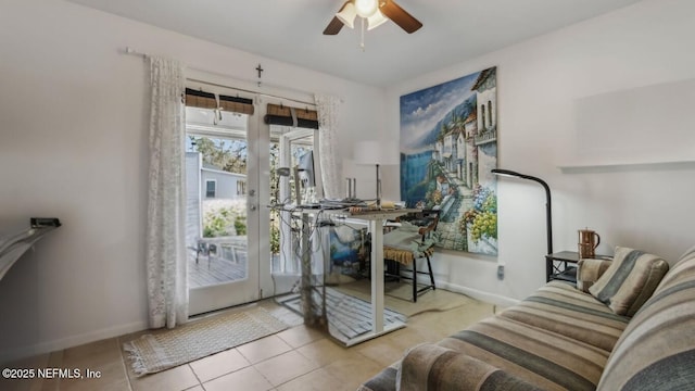 interior space featuring baseboards and ceiling fan