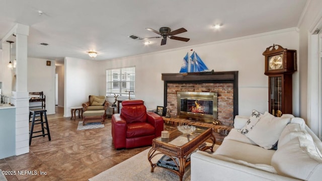 living area with visible vents, ceiling fan, a fireplace, and ornamental molding