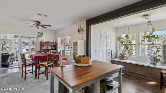 dining space featuring visible vents, a ceiling fan, and wood-type flooring