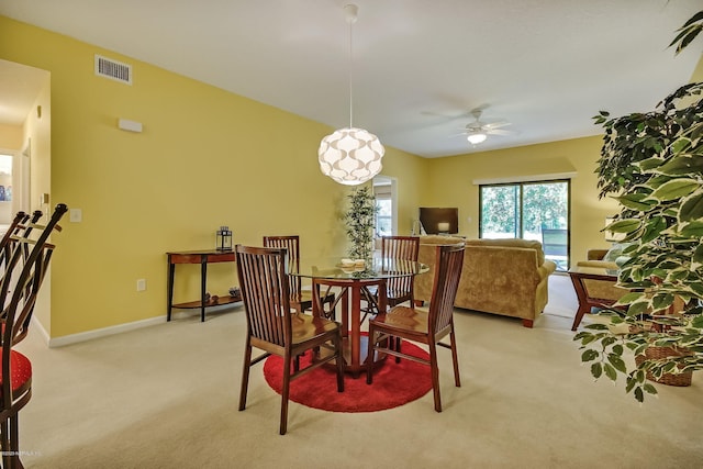 carpeted dining space featuring ceiling fan