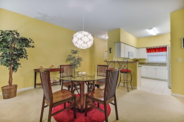 carpeted dining area with sink