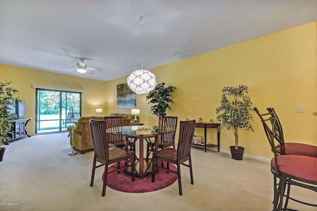 carpeted dining space featuring ceiling fan