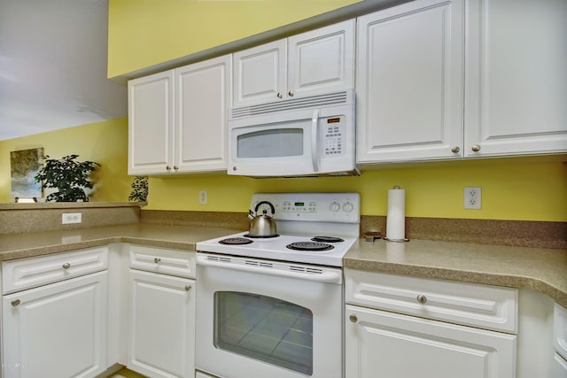 kitchen with white cabinetry and white appliances