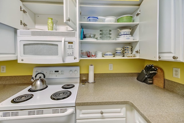 kitchen with white appliances and white cabinets