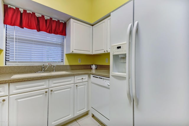 kitchen featuring light tile patterned flooring, sink, white cabinets, and white appliances