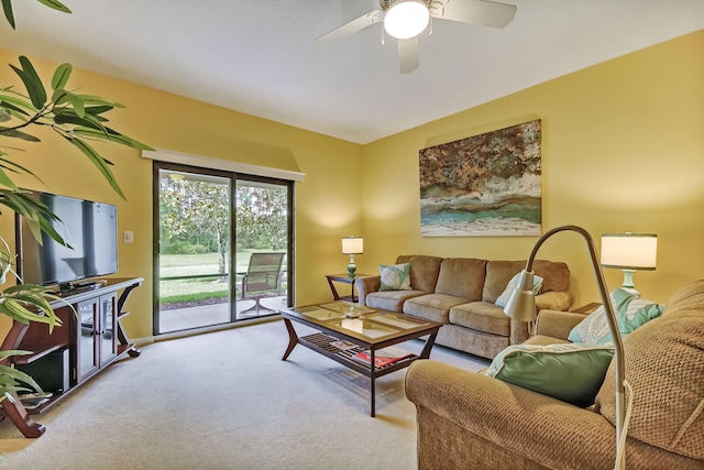 carpeted living room with ceiling fan