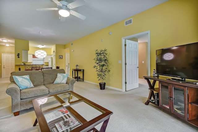 living room with ceiling fan and light colored carpet