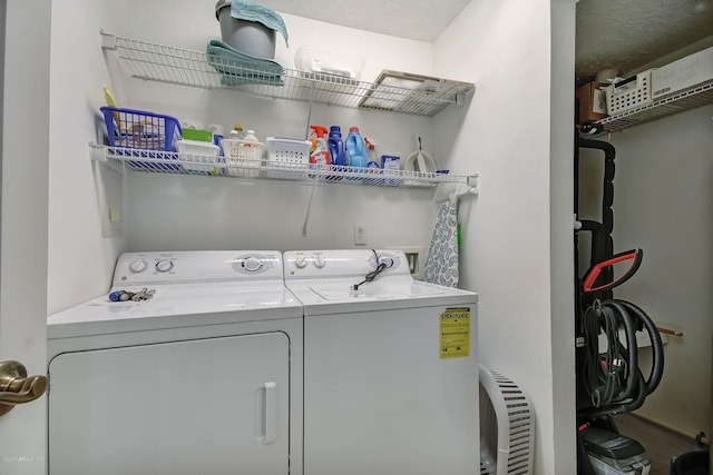 clothes washing area featuring washer and clothes dryer