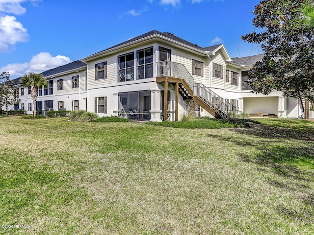 109 Laurel Wood Way Unit 103, Saint Augustine, FL 32086 - back of house featuring a sunroom and a yard