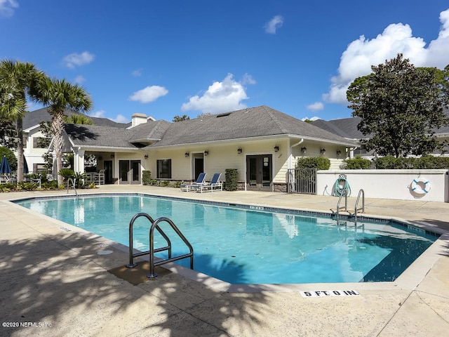 view of pool featuring a patio area and french doors