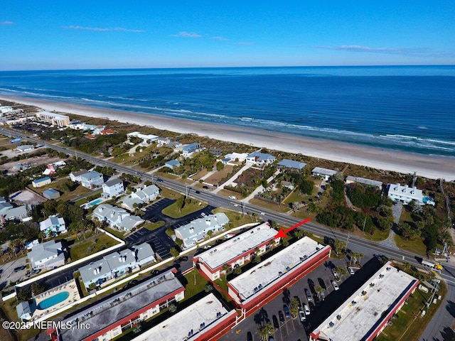 bird's eye view featuring a water view and a beach view