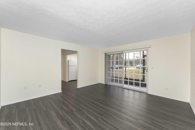 unfurnished room with dark wood-type flooring and a textured ceiling