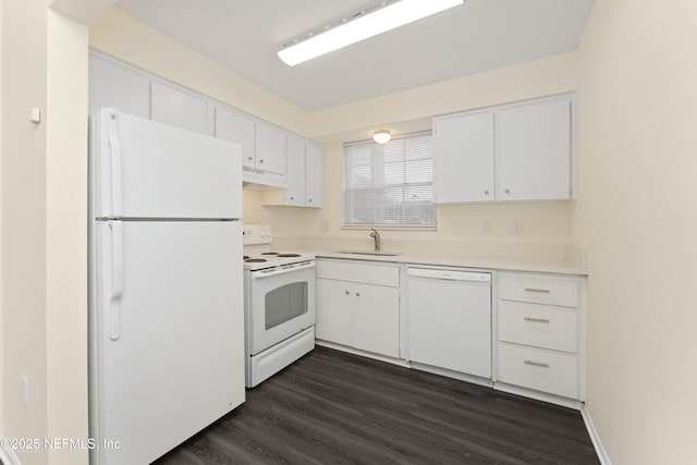 kitchen with white cabinetry, sink, dark hardwood / wood-style floors, and white appliances