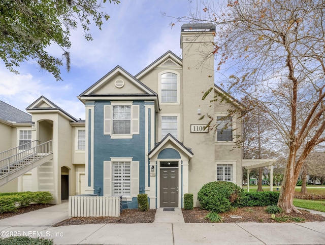 townhome / multi-family property with a pergola