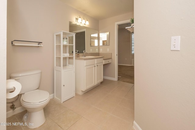 bathroom featuring tile patterned flooring, vanity, and toilet