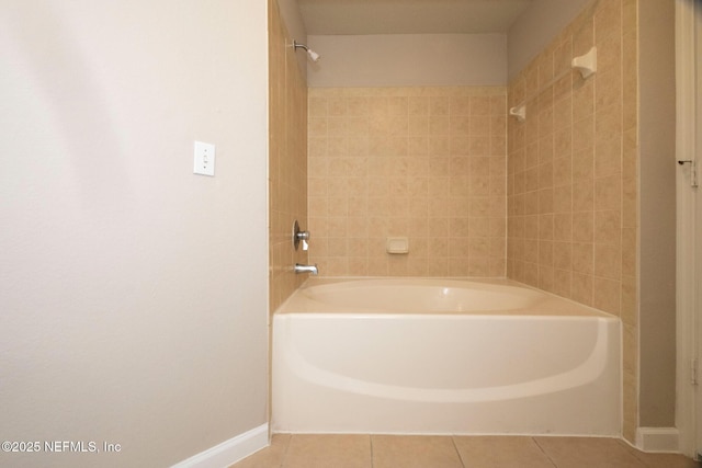 bathroom featuring tile patterned floors, tub / shower combination, and baseboards