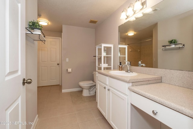 bathroom with tile patterned floors, toilet, a textured ceiling, vanity, and a shower with door