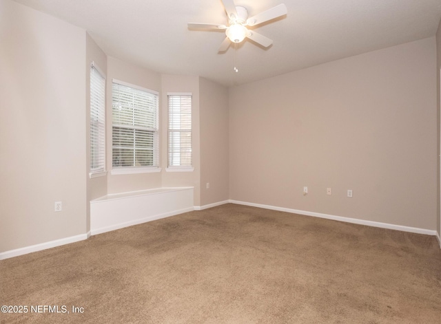 carpeted spare room with ceiling fan