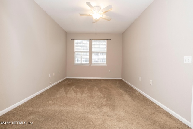 carpeted empty room with baseboards and ceiling fan