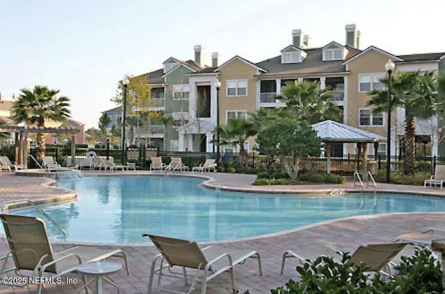 view of swimming pool with a patio