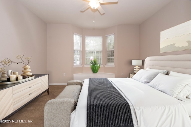 bedroom featuring baseboards, dark colored carpet, and ceiling fan