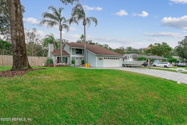 view of front facade with a front yard and a garage