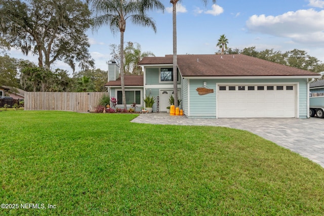 view of front of house featuring a garage and a front lawn